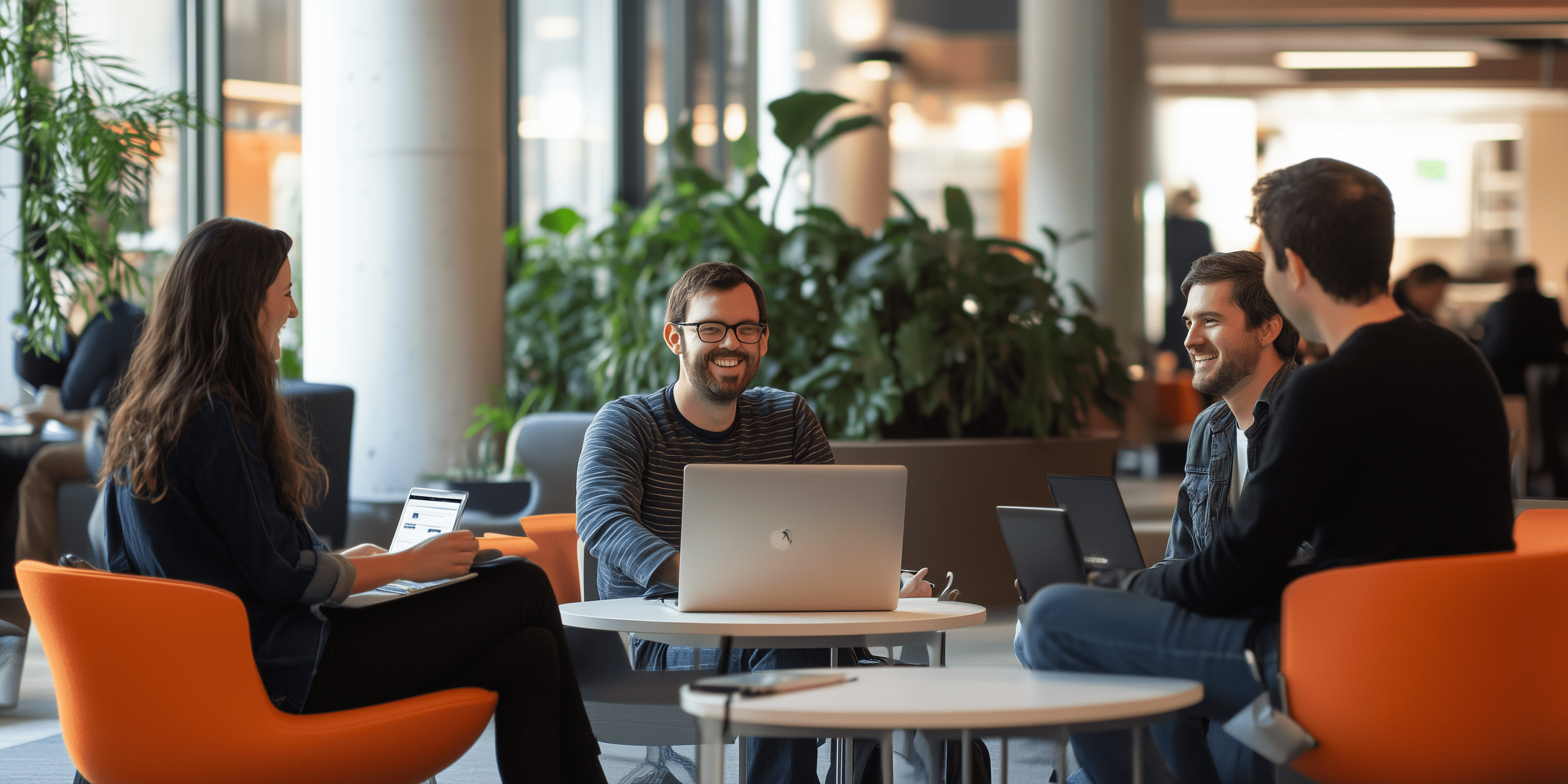 Smiling office workers sitting in an open interior space